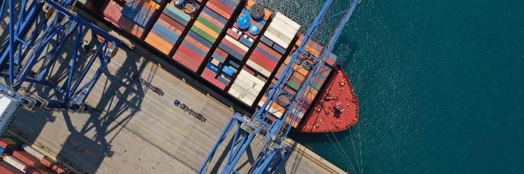 aerial top down ultra wide photo with copy space of industrial cargo container ship loading in logistics terminal port